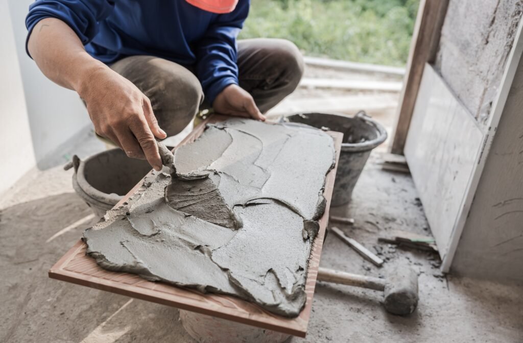 Hand worker tile installation interior wall kitchen home with trowel cement glue, Tilling technician