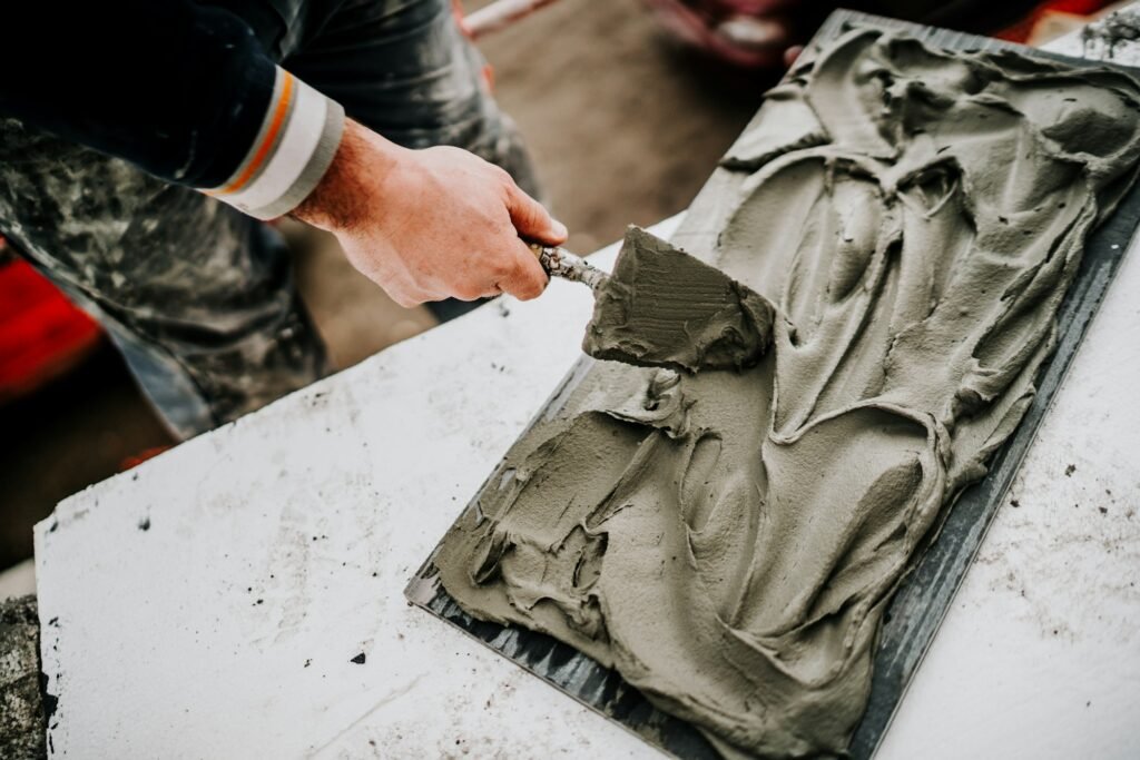 Industrial worker, builder working on stone tiles.