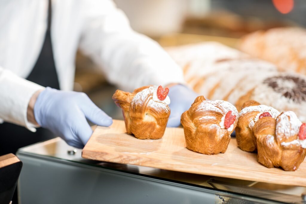 Putting maffins in the bakery store