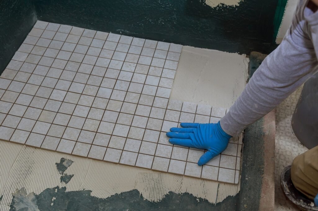 Bathroom laying floor tile unfinished construction in apartments